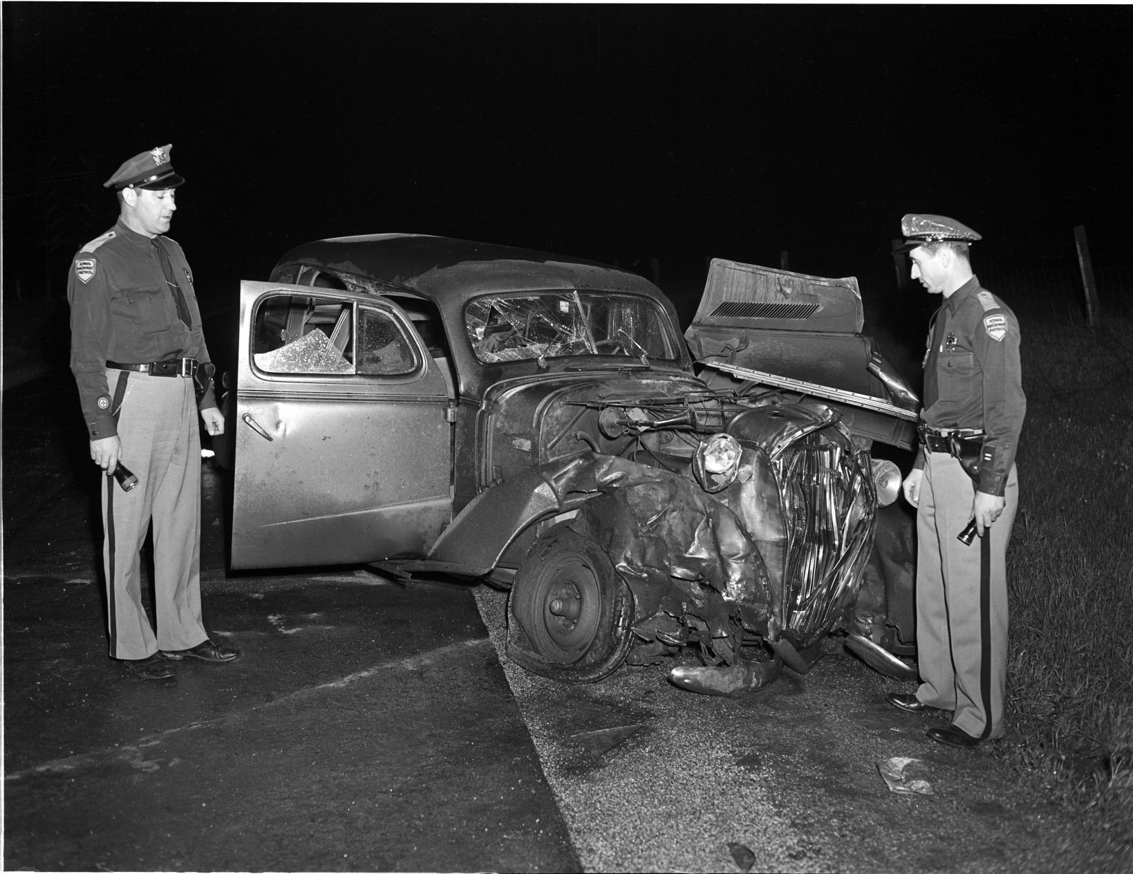 Highway patrolmen at accident scene